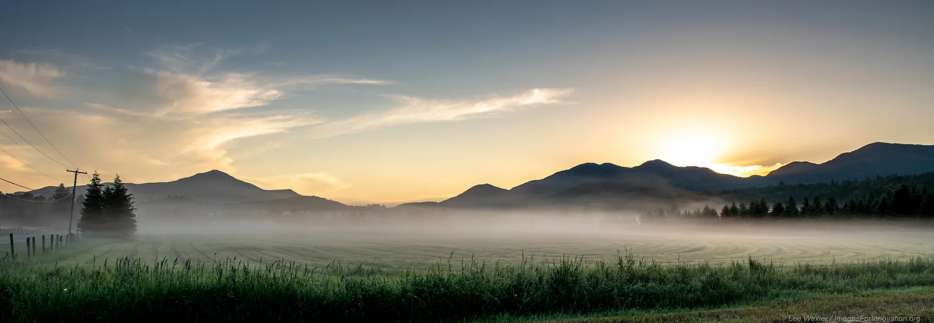 barren landscape with mountains and fog and sun